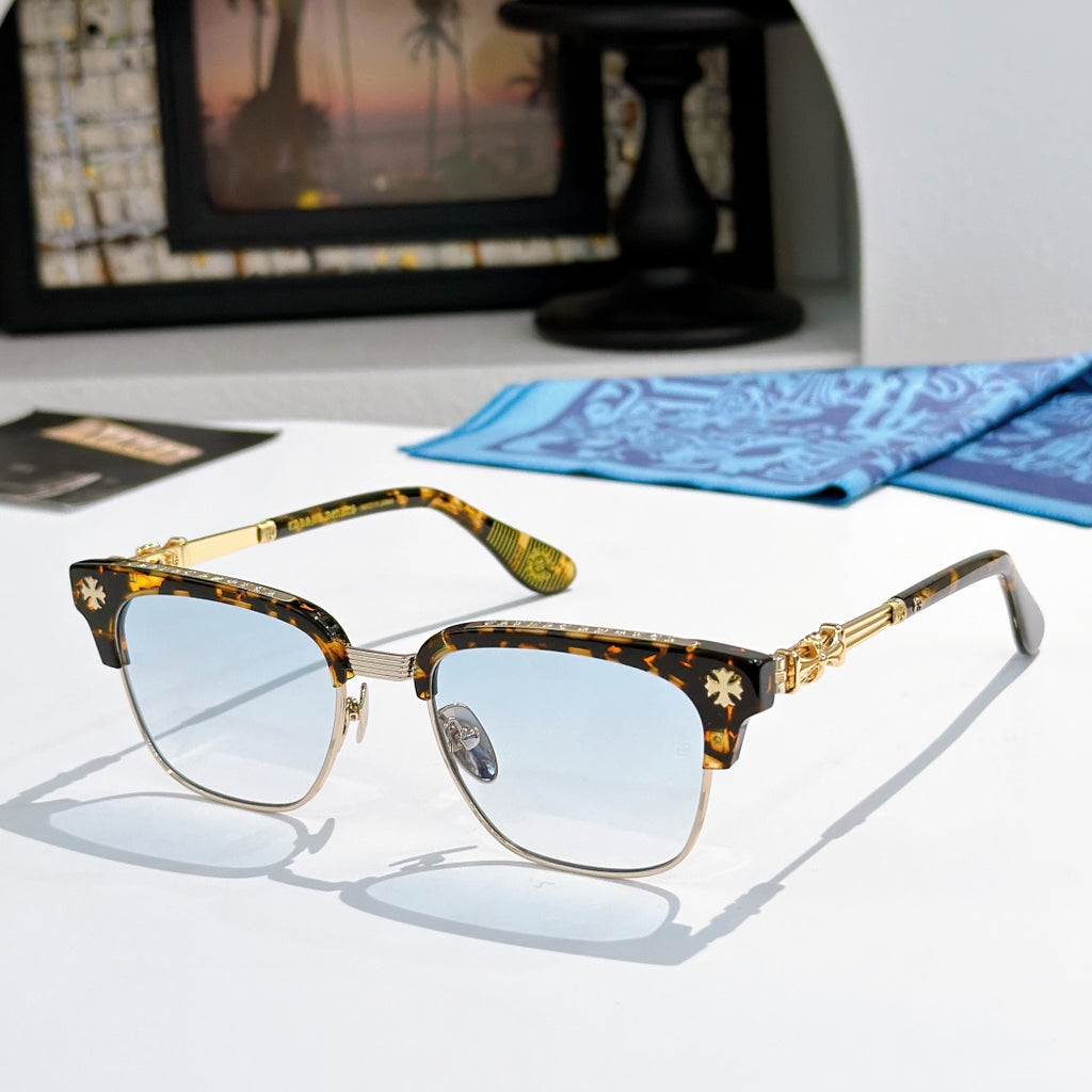 Chrome-framed glasses with tortoiseshell arms, gold accents, and light blue lenses