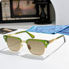 Chrome-framed glasses with green frame accents and amber-tinted lenses