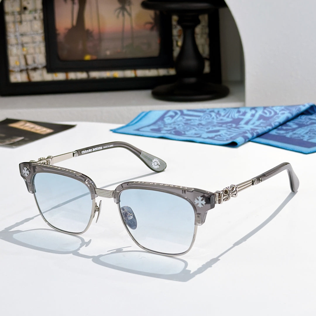 Chrome-framed glasses with gray frames, gold hinge detail, and light blue lenses