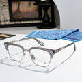 Metal eyeglasses with clear lenses, dark gray frame, and decorative side temples