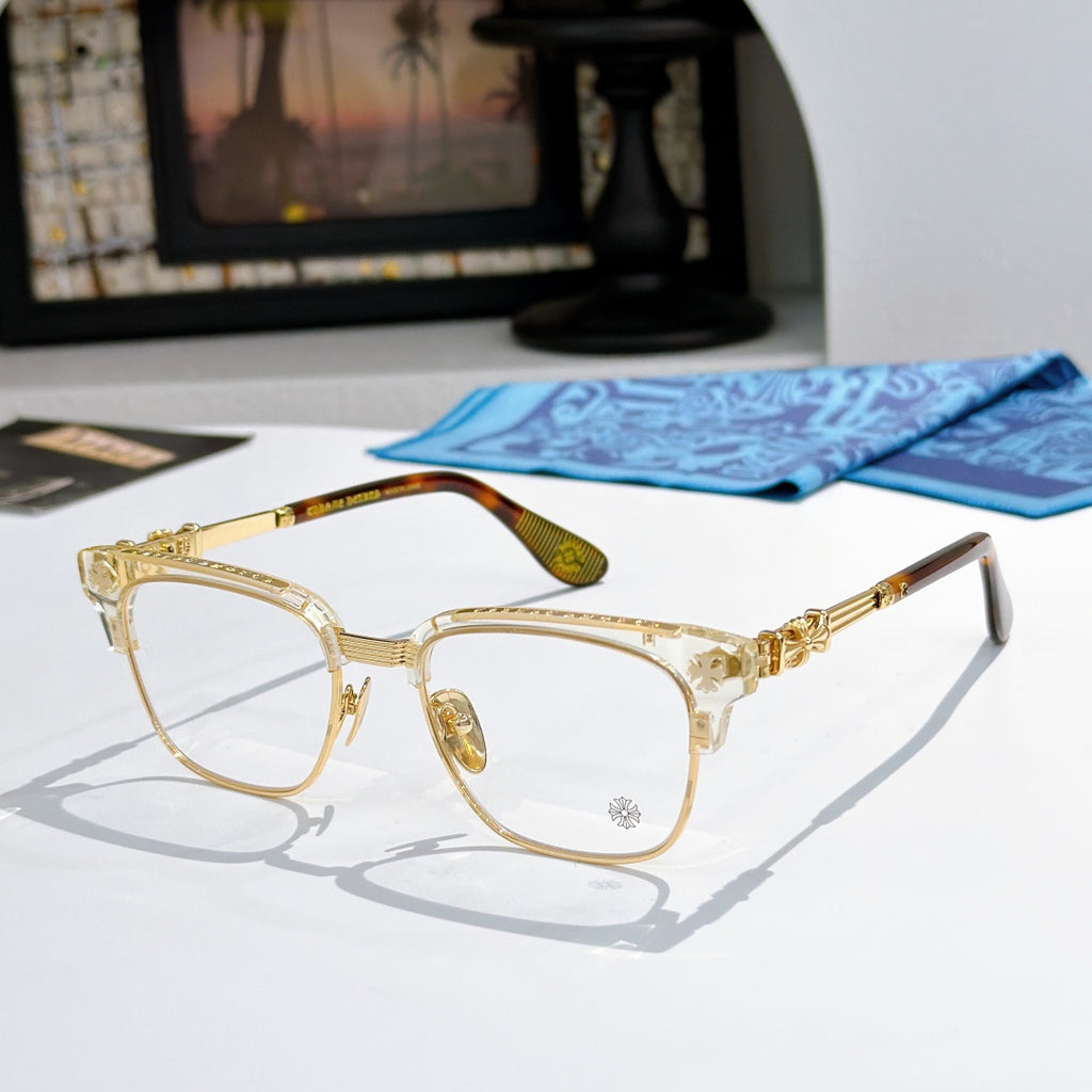 Metal eyeglasses with clear lenses, gold-toned frame, and patterned side temples