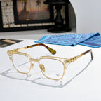 Metal eyeglasses with clear lenses, gold-toned frame, and patterned side temples