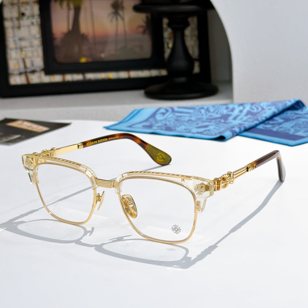 Metal eyeglasses with clear lenses, gold-toned frame, and patterned side temples