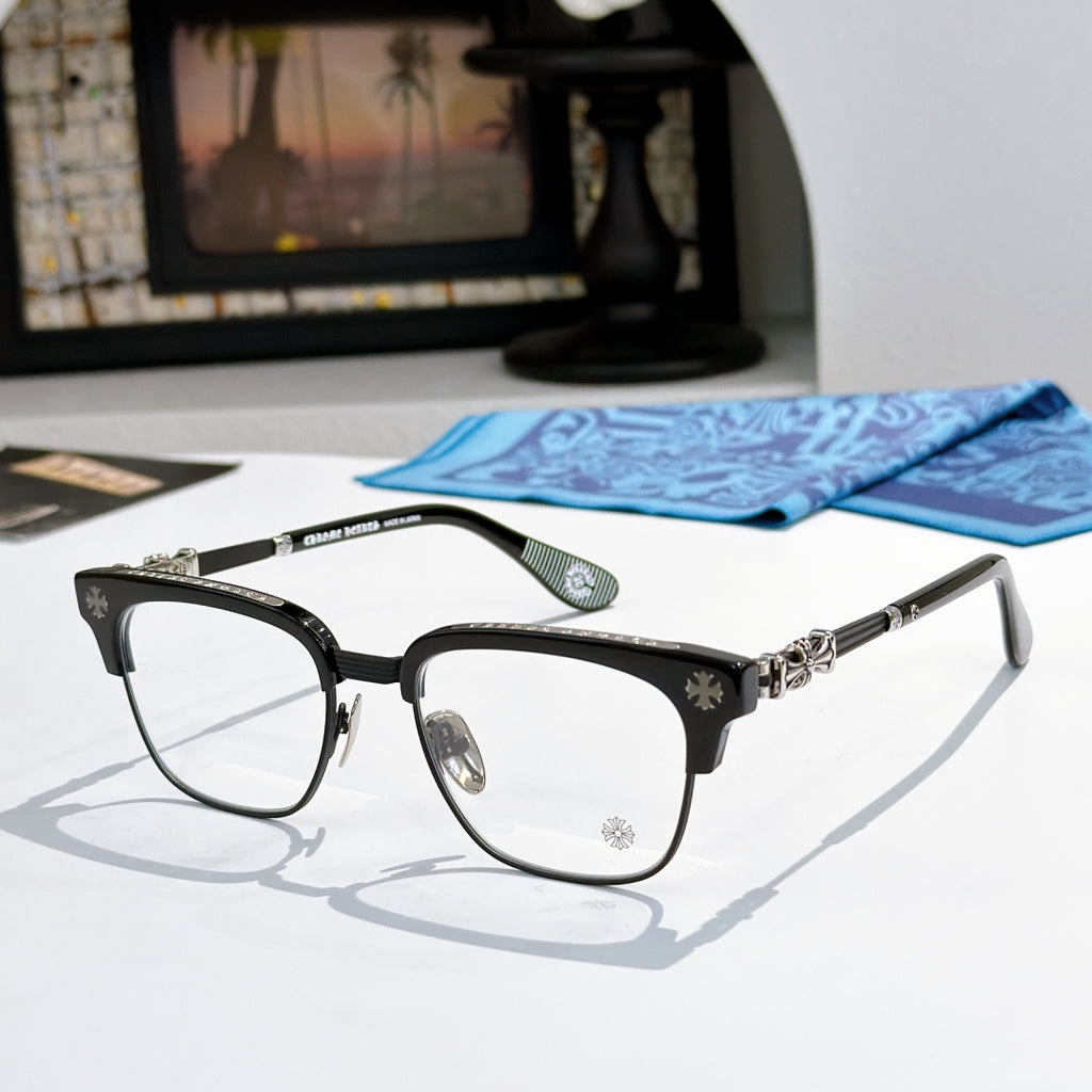 Metal eyeglasses with clear lenses, black frame, and silver-toned decorative temples