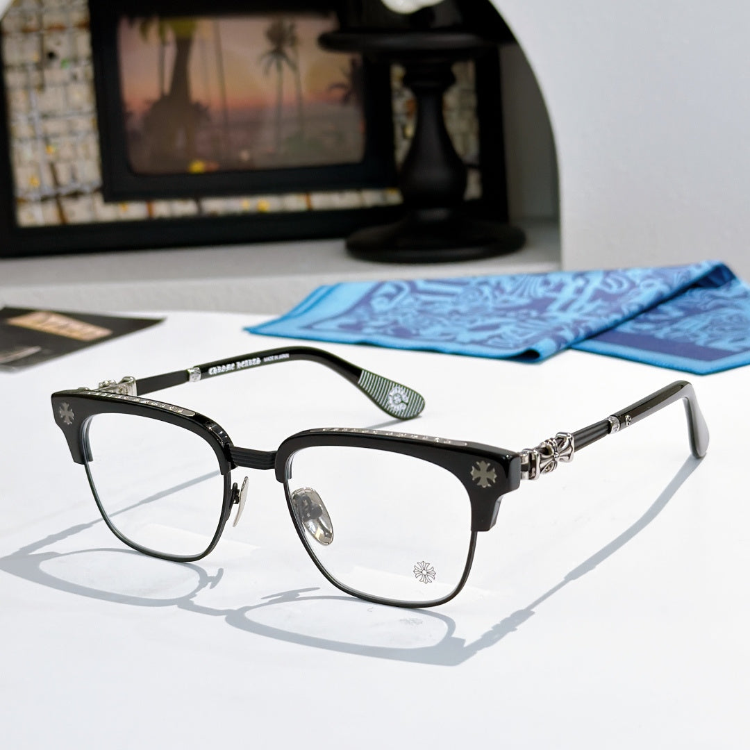 Metal eyeglasses with clear lenses, black frame, and silver-toned decorative temples