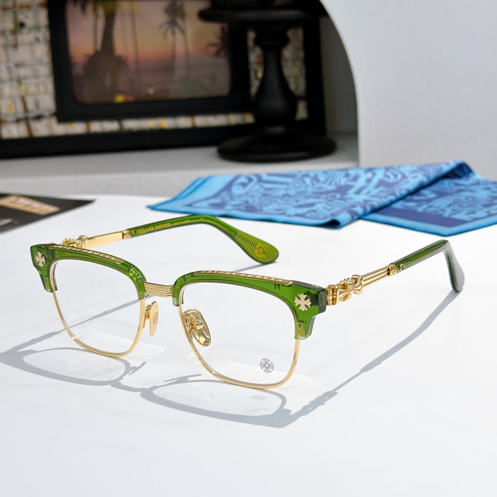 Metal eyeglasses with clear lenses, green frame, and gold-toned decorative temples