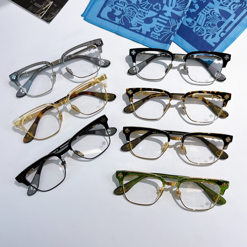 Set of assorted eyeglasses with clear lenses in black, gold, green, and gray frames