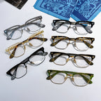 Set of assorted eyeglasses with clear lenses in black, gold, green, and gray frames