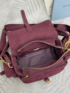 Burgundy suede Prada bag interior view with gold zip and stitched pocket panels