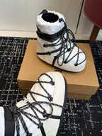 White and black lace-up winter boot with padded lining and thick black ankle strap