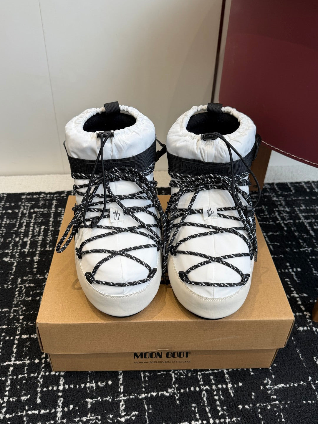White and black lace-up winter boots with padded cuffs and black detailing