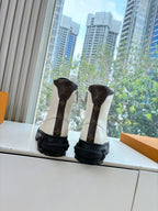 White leather lace-up ankle boots with Louis Vuitton logo heels and black soles
