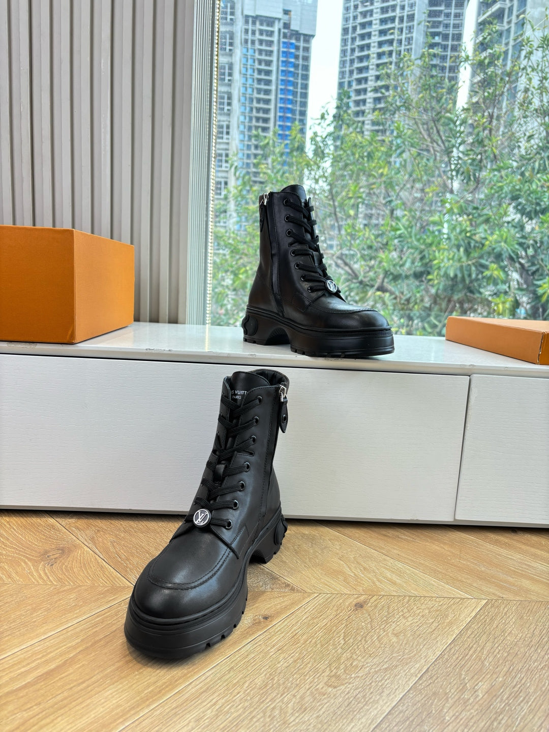 Louis Vuitton unisex lace-up boots, black leather, two-quarter view on display