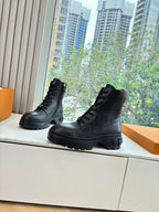 Louis Vuitton unisex lace-up boots, black leather, side view with chunky tread sole