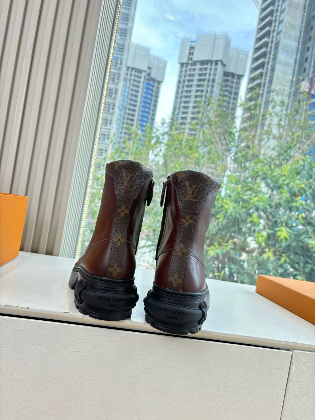 Brown monogram leather lace-up boots with black rubber sole
