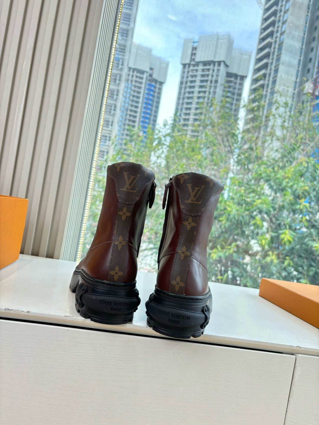 Brown monogram leather lace-up boots with black rubber sole
