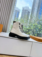 White leather lace-up ankle boot with black laces and treaded black sole