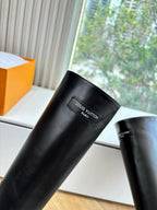 Black leather knee-high boot with Louis Vuitton logo patch on shaft