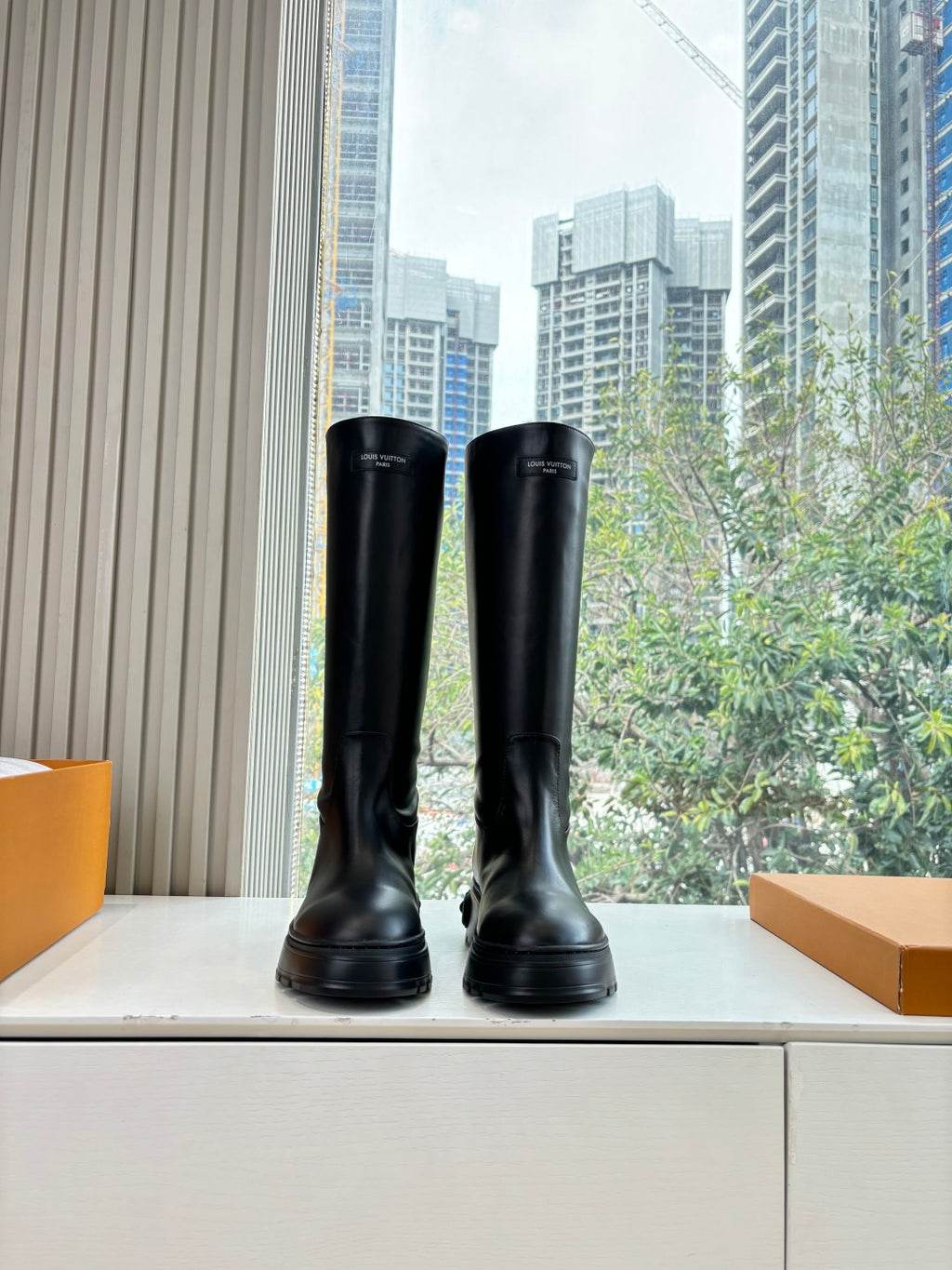 Black leather knee-high boots with thick rubber sole, front view