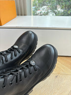 Louis Vuitton unisex black leather boots, lace-up toe close-up with side emblem
