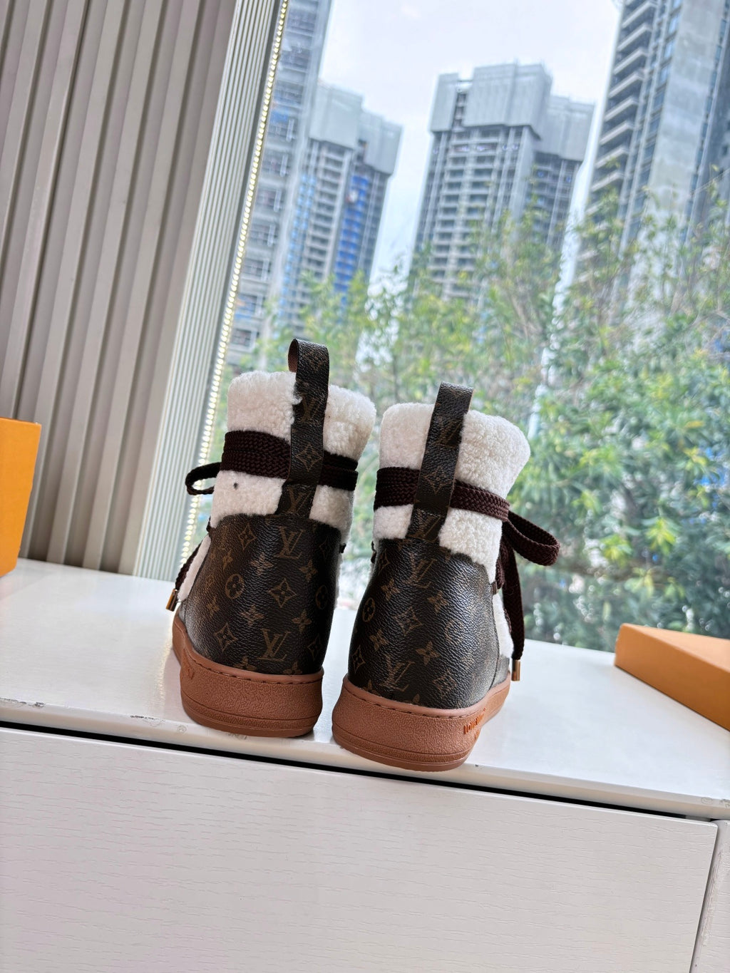 High-top sneakers with Louis Vuitton monogram canvas, dark laces, and shearling lining