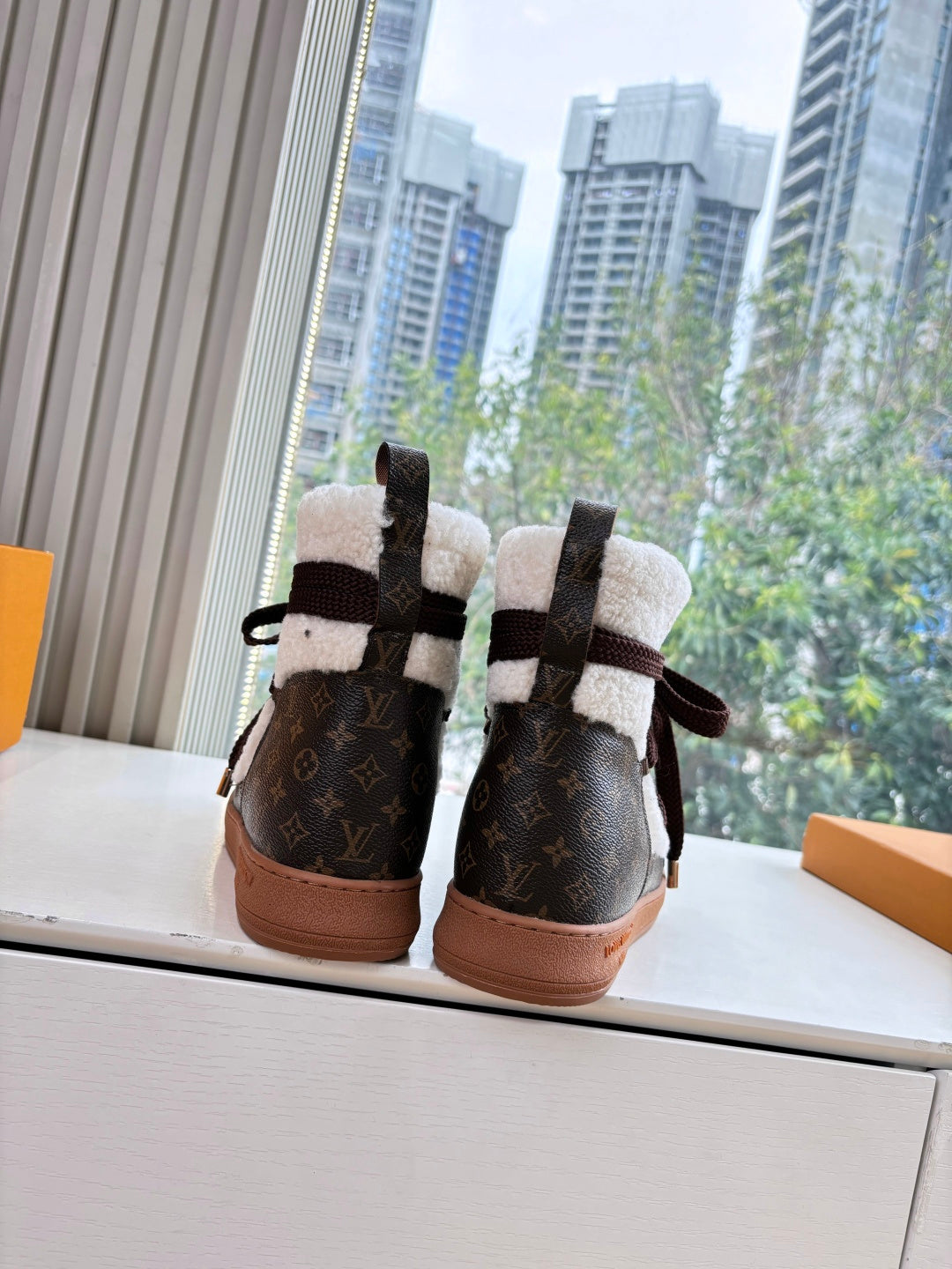 High-top sneakers with Louis Vuitton monogram canvas, dark laces, and shearling lining