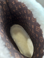 Monogram fabric upper close-up with faux shearling trim and lace eyelets