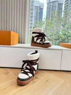 High-top sneakers with dark laces, white shearling cuffs, and tan gum soles