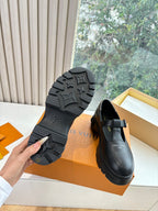 Louis Vuitton loafers with textured rubber outsole, black leather upper