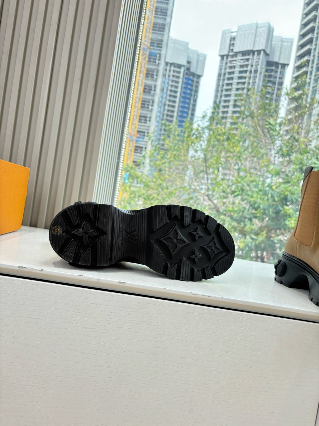 Black rubber boot outsole with star-like tread pattern.