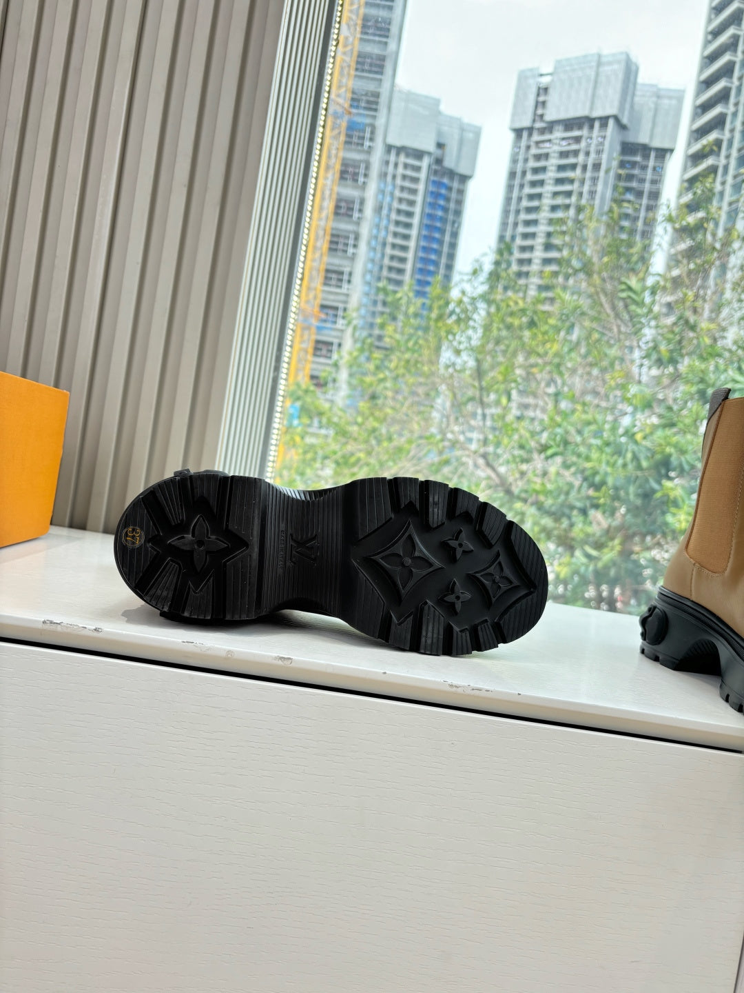 Black rubber boot outsole with star-like tread pattern.