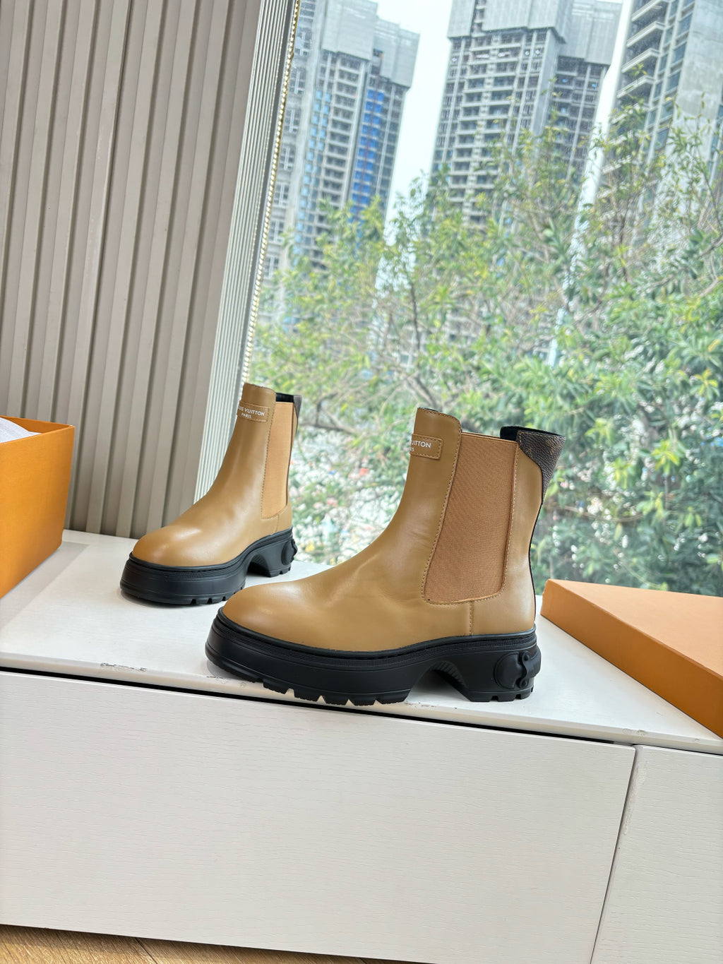 Tan leather Chelsea boot with side elastic gore and black rubber sole.