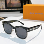 Louis Vuitton shades with black frames and dark lenses, gold logo detail on temple