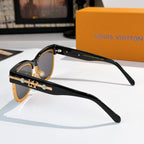 Louis Vuitton sunglasses with black frames and dark lenses, gold logo detail on temple