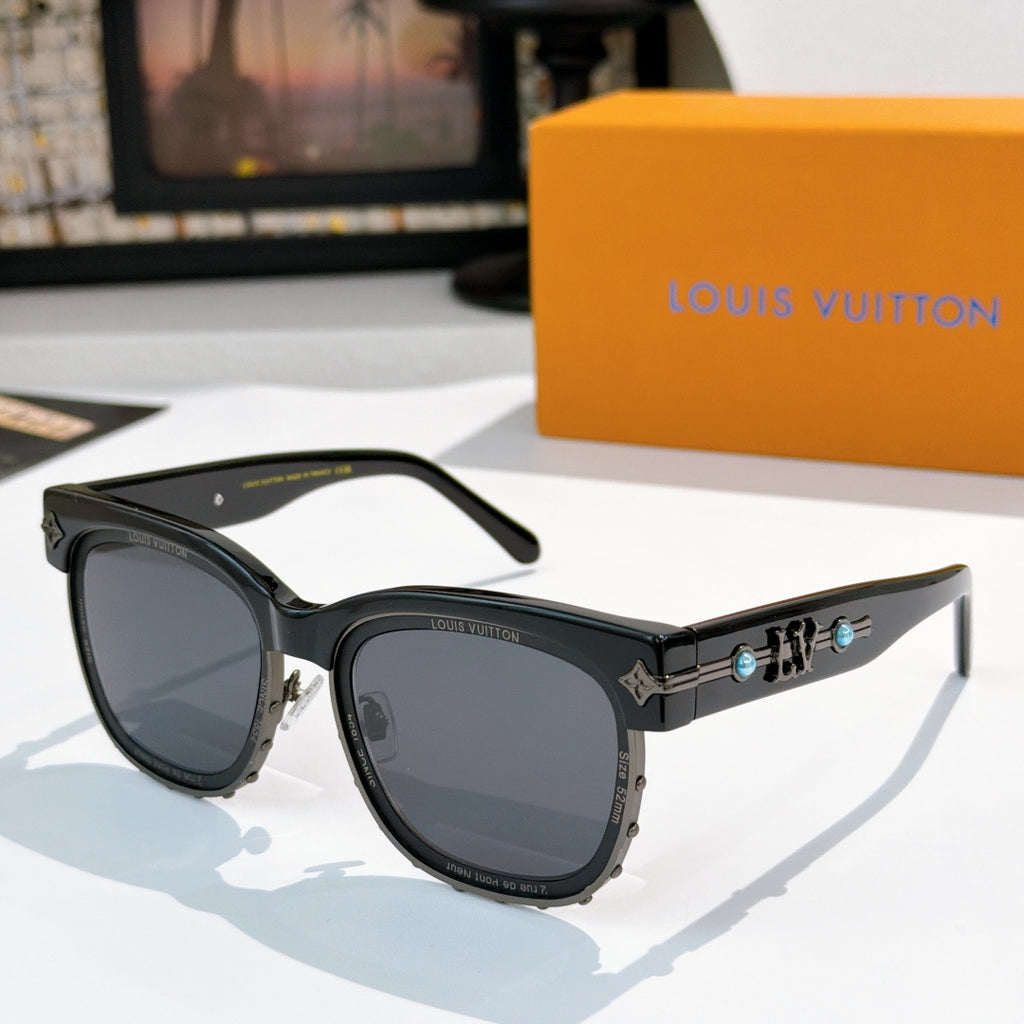 Louis Vuitton shades with black frames and dark lenses, gold logo detail on temple