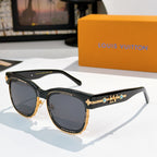Louis Vuitton shades with black frames and dark lenses, gold logo detail on temple