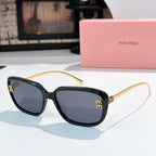 MiuMiu black sunglasses with rounded square frames, tinted lenses, and gold logo