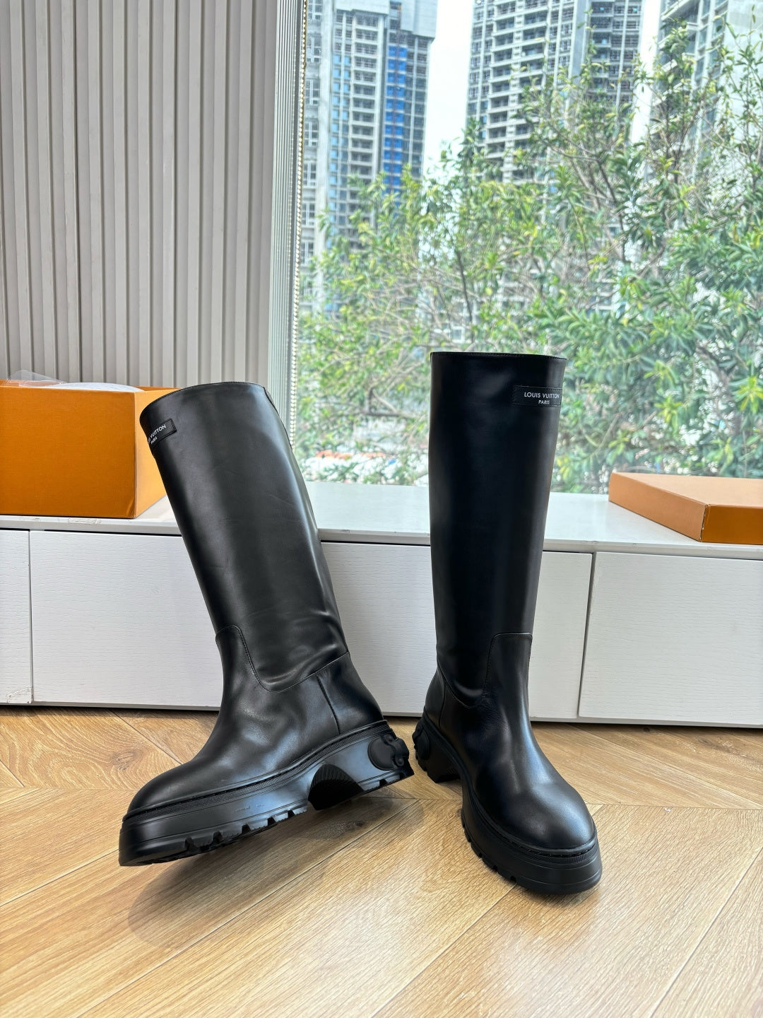 Black knee-high leather boots, two-shoe angled view