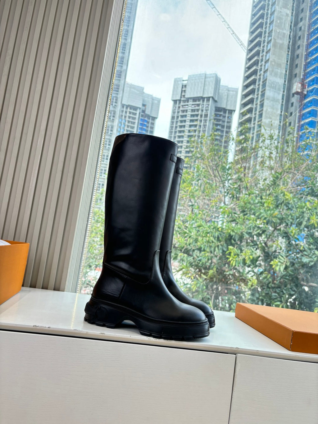 Black knee-high leather boots, three-quarter view