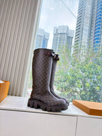 Louis Vuitton monogram tall boot with buckle strap and chunky lug sole, side view