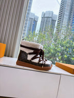 High-top sneakers with faux shearling collar, dark laces, and tan rubber sole