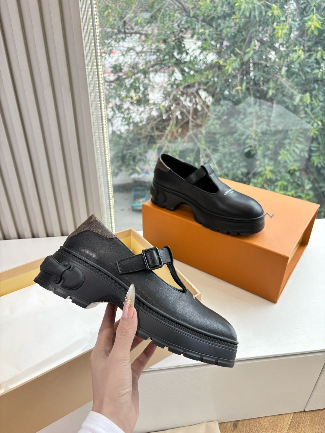 Louis Vuitton leather loafers, black, side view with chunky rubber sole