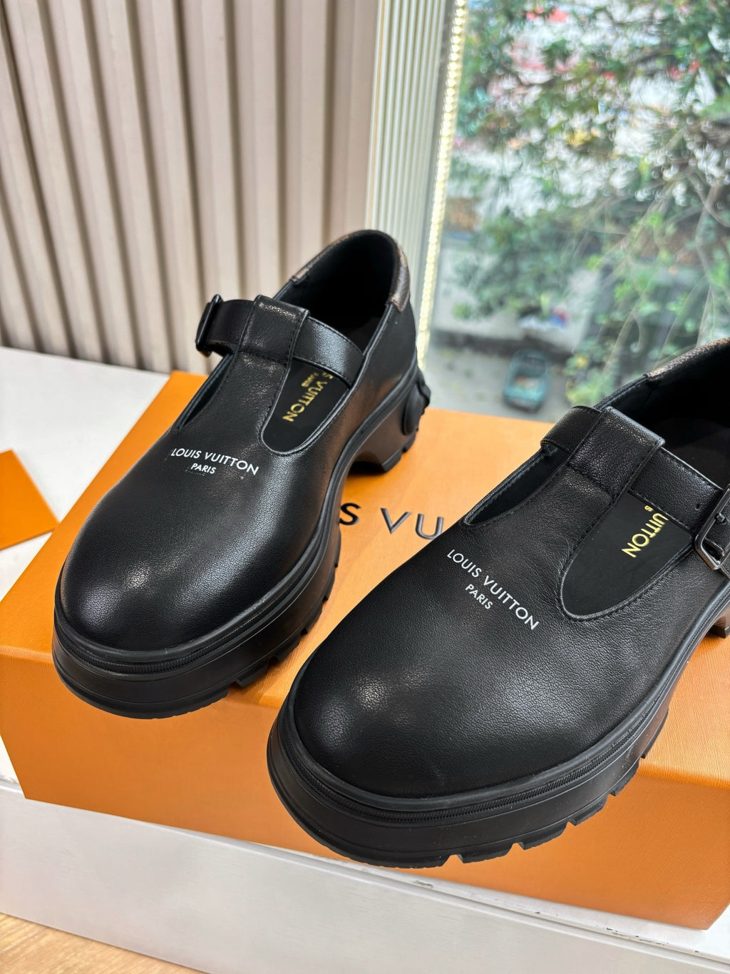 Louis Vuitton leather slip-on loafers, black, close front view with strap