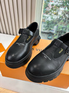 Louis Vuitton leather slip-on loafers, black, close front view with strap