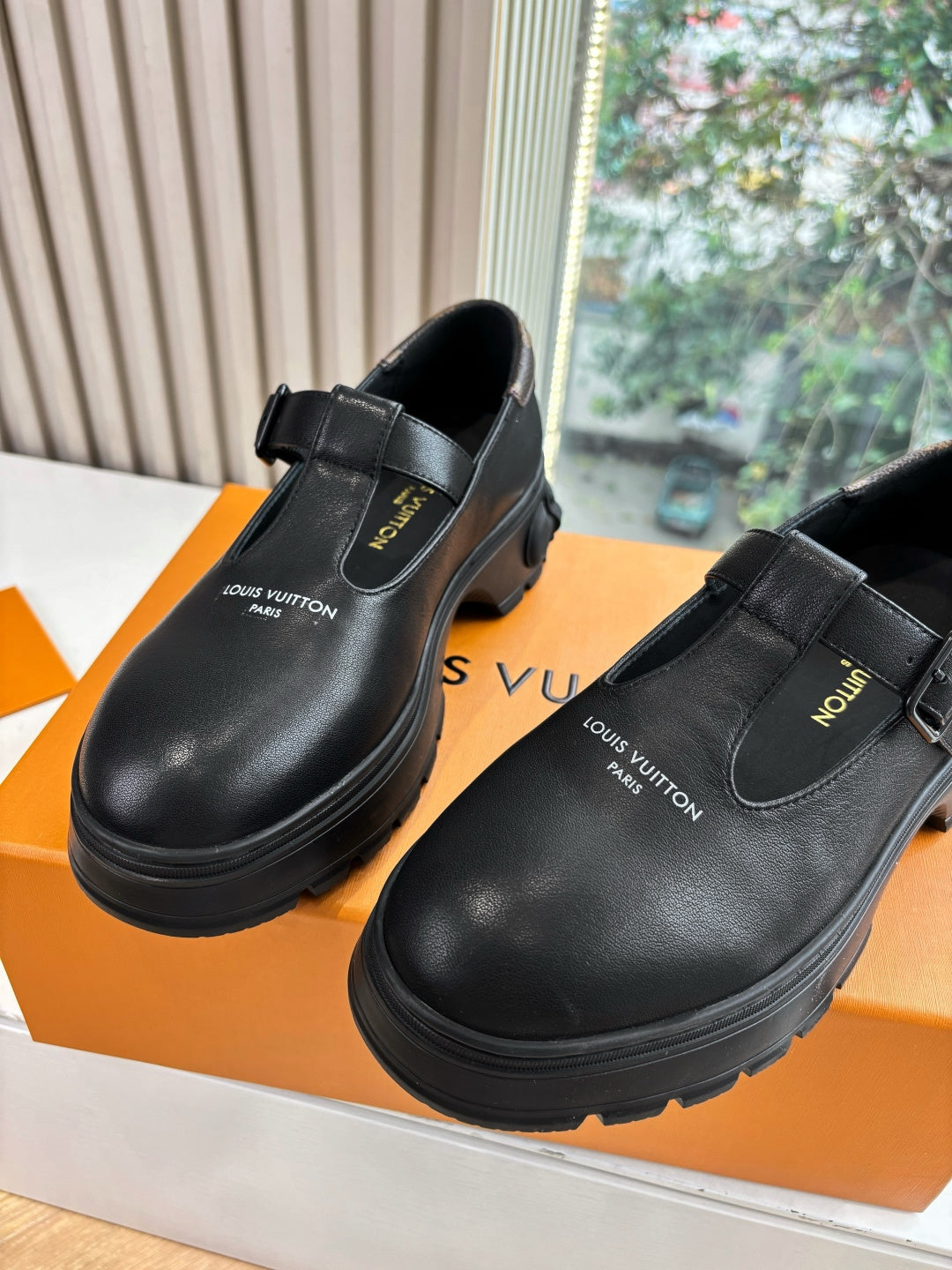 Louis Vuitton leather slip-on loafers, black, close front view with strap