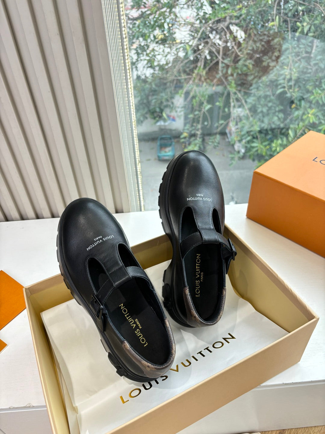 Louis Vuitton leather loafers, black slip-on style with adjustable strap