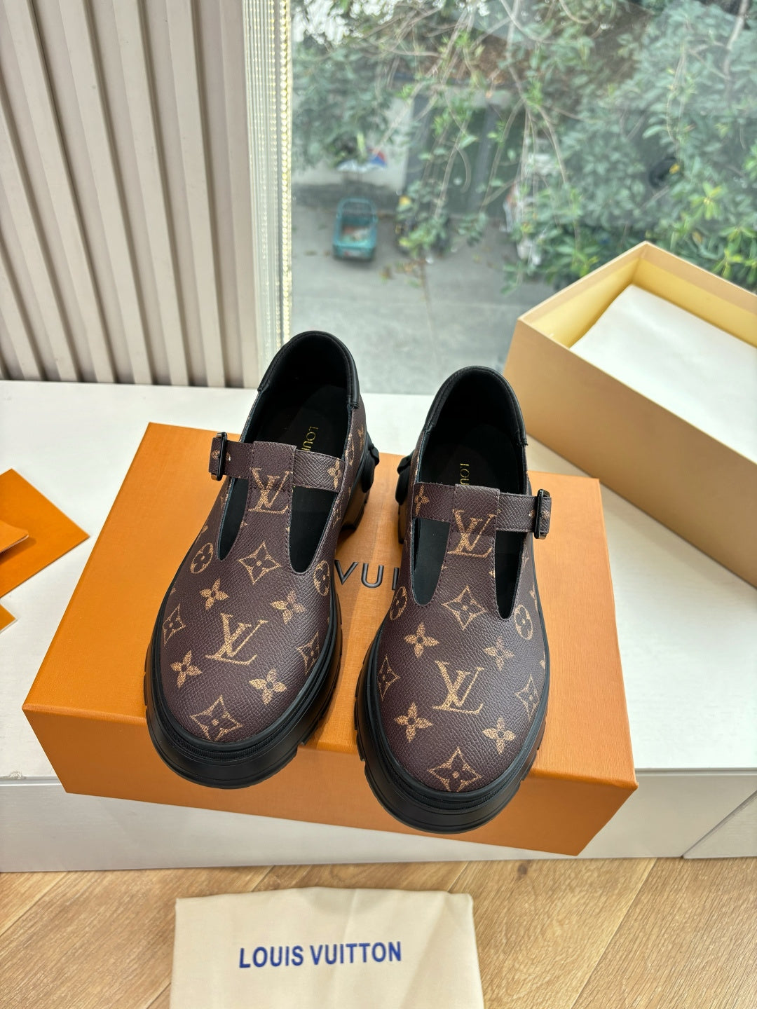 Monogram slip-on shoes on box, dark brown canvas with black buckle straps and sole