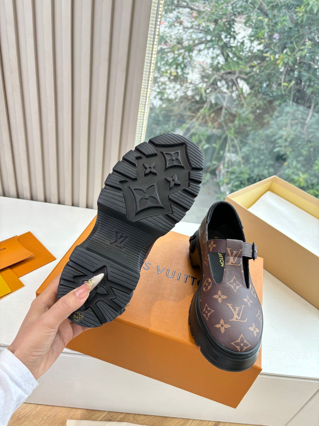 Monogram slip-on shoe outsole view, textured rubber tread on black sole