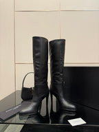 YSL ladies knee-high black leather boots with slim heel, front view