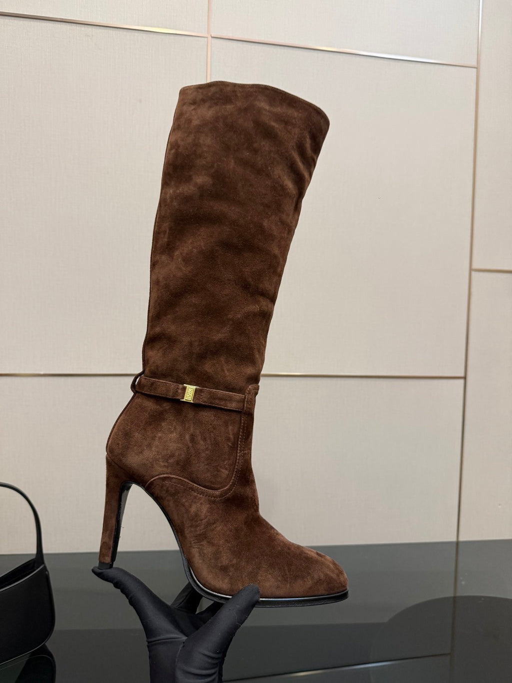 YSL women’s suede knee-high boot, brown, gold buckle strap and curved seam lines
